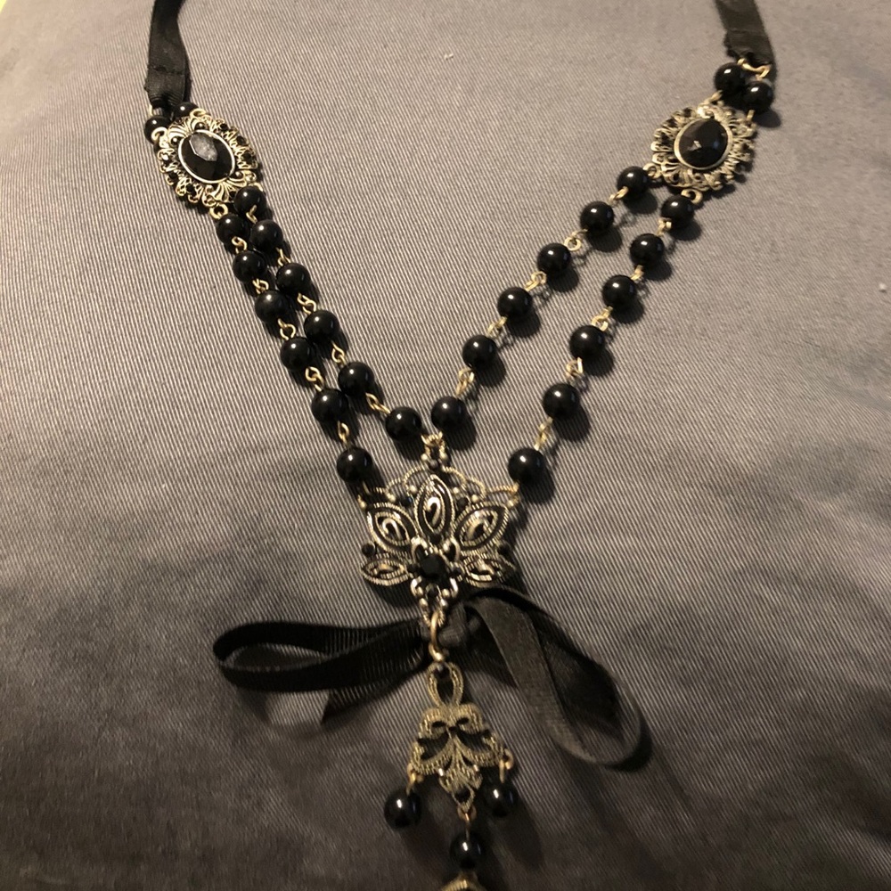 Black and silver necklace on black ribbon. Goth.